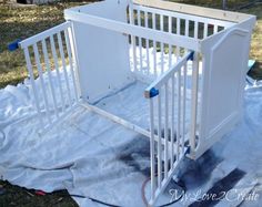 a baby crib is being painted in the yard