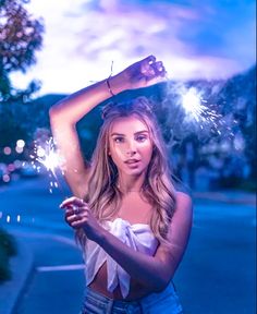 a woman holding sparklers in her hand with the caption have a great weekend