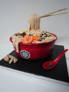 a cake made to look like a bowl of noodles with chopsticks