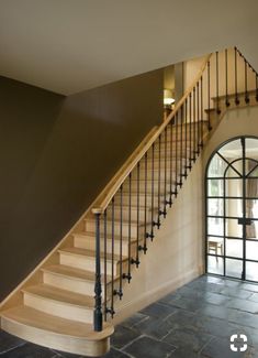 a staircase in a house with stone flooring