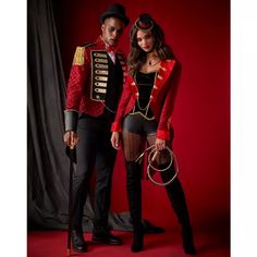 a man and woman dressed up in costume posing for a photo on a red background