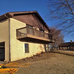 a two story building with a garage in the foreground