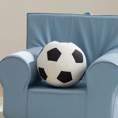 a soccer ball sitting on top of a blue chair