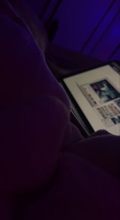 a person laying in bed with a tablet on their lap