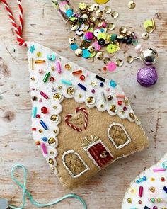 a gingerbread house ornament surrounded by christmas decorations