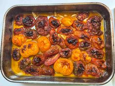 a metal pan filled with raisins on top of a table