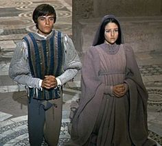 a man and woman dressed in medieval clothing standing next to each other on the floor