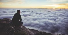 a man sitting on top of a mountain with a quote above it that reads, i want to sing like the birds sing, not worrying about who hears what they think