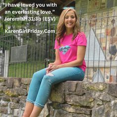 a woman sitting on top of a stone wall next to a fence with a quote above her