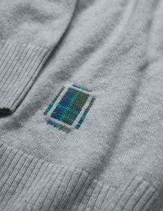 a close up of a sweater with a patch on the chest and an image of a window