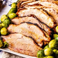 sliced pork and brussel sprouts on a platter