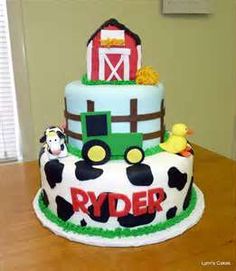 a three tiered cake decorated with farm animals