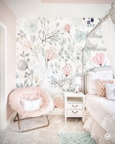 a bedroom with floral wallpaper and pink chair