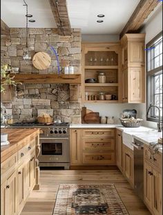 a kitchen with wooden cabinets and stone wall in the backround, along with a rug on the floor