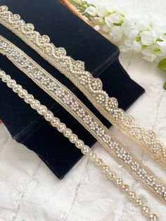 This stunning lace trim is great for any sewing and craft projects : FR- 3007 ➤wedding decoration or holiday decoration. ➤straps for funky bags or your Guitar ➤dress border, dupattas, scarves and veils  ➤headband, hats ➤jewellery making, ➤for making a DIY belt ➤book binding embellishment,  ➤designing stylish blouses, ➤waist belt to match your plain outfit  ➤shrugs, skirts, tunics,  ➤festive wear, wedding wear, dresses  ➤Gypsy, Boho , Bohemian Ethnic wear, tunics and salwar/Kurtis. ➤Embellish you Gold Lace Wedding Fabric And Notions, Gold Lace Fabric For Wedding, Gold Lace Wedding Fabric, Elegant Gold Fabric And Notions For Wedding, Gold Embellished Trims For Wedding, Elegant Wedding Lace Work Trims, Elegant Wedding Trims With Lace Work, Elegant Wedding Lace Trims, Wedding Wear Dresses