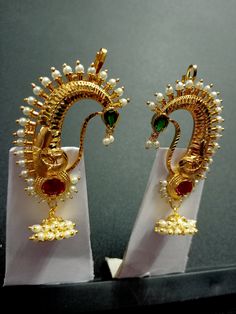 Type : Long Jhumki Earrings || Material : Alloy ||  Colour : Red Green Gold || Plating : Gold Plated || Finish : Glossy & Matte Size : Free Size || Package Contains : 1 Earring Pair | Handmade Indian Jewelry item* Maharashtrian Traditional look Bugdi Clip On Pressing Type earrings for women. They are studded with sparkling stones with pearl beads. Easy to use and comforatble to hold as they are clip-on for Upper Ear It will be more graceful if you wear it with Nauvari paithani , kanjivaram , Maheshwari or Chanderi silk saree. IDEAL GIFTS FOR WOMEN - Come in an elegant jewelry Pouch perfect for any gift giving occasion. Great gifts for women, gifts for girlfriend, gifts for mom, gifts for mother in law, gifts for wife, gifts for daughter, gifts for granddaughter, gifts for aunt, gifts for b Festive Temple Jewelry Single Earring, Elegant Peacock Design Earrings For Puja, Gold Earrings With Peacock Design For Puja, Chandbali Peacock Earrings For Puja, Peacock Design Chandbali Earrings For Puja, Peacock Design Earrings For Puja Festivals, Festival Peacock Design Earrings For Puja, Ceremonial Chandbali Earrings With Peacock Design, Ceremonial Peacock Chandbali Earrings