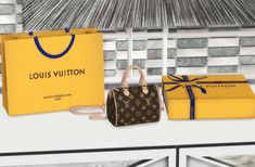 the louis vuitton bag is next to two yellow boxes