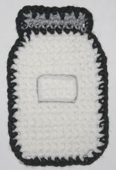 a crocheted black and white object with a square on it's side