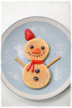 a pancake shaped like a snowman on a plate