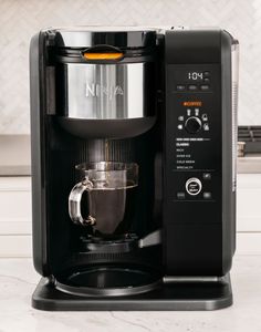 a black coffee maker sitting on top of a counter