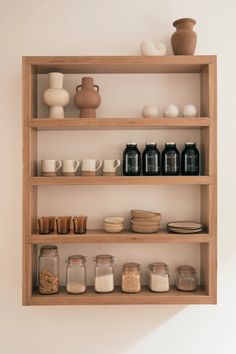 shelves with jars, bowls and vases on them