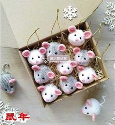 a box filled with knitted mice next to snowflakes