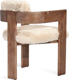 a wooden chair with sheepskin on the seat