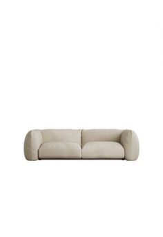 a white couch sitting on top of a white floor