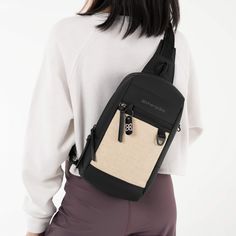 a woman wearing a black and beige backpack