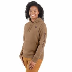 Cold winter mornings are a lot more comfortable with this women's cozy hoodie. Made of heavyweight fleece, the sweatshirt is brushed on the inside for extra softness. It has a relaxed fit that allows for easy layering, and it's finished with a Carhartt logo down the sleeve. Features10.5-ounce, 73% cotton / 27% polyesterThree-piece hood with drawcordRib-knit cuffs and waist help keep out the coldFront pouch pocketCarhartt signature logo printed on sleeve; Carhartt 'C' graphic on frontModel in Bla Carhartt Logo, Carhartt Womens, Safety Clothing, Winter Mornings, Flaxseed, Cozy Hoodie, Women Hoodies Sweatshirts, Flax Seed, Knit Cuff