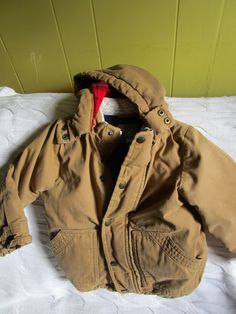 This little outdoorsy, warm unisex jacket is perfect for Fall play! It is in good used condition (see photo #3 for stain on sleeve, which in no way affects the warmth or usefulness of this jacket). Flannel lined hood-fleece quilted lining. Warm Hooded Jacket For Outdoor, Warm Cotton Hooded Jacket For Outdoor, Winter Camping Outerwear With Pockets, Winter Outerwear With Pockets For Camping, Hooded Outerwear With Fleece Lining For Camping, Long Sleeve Fleece-lined Outerwear For Camping, Winter Adventure Hooded Jacket, Hooded Winter Jacket For Adventure, Winter Camping Long Sleeve Outerwear