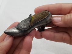 This 1930's shoe is made of pewter and has a lovely detailed buckle that features the rotunda and government buildings of Washington DC.  It has a nice weight to it and would be a great addition to the miniture collector, travel memorabilia,  sewing enthusiasts and a unique accent for your home décor design. This shoe is in good condition.  We take care to inspect and clean our vintage items before offering them to you for sale. By so doing we can ensure that you are getting a quality item. We also take detailed photos.  Vintage items have the patina of time and the decades they have spent out in the world. This is part of the charm and appeal of buying well designed vintage and  antique items! Dimensions 1.25 ins./3.17 cm. Overall Height  2.25 ins / 7.62 cm. Long  1 ins./ 2.54 cm. Opening 1930s Shoes, Travel Memorabilia, Photos Vintage, Detailed Photos, Pin Cushion, Antique Items, Pin Cushions, Washington Dc, High Heel Shoes