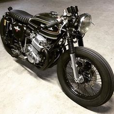 a black motorcycle parked in a garage