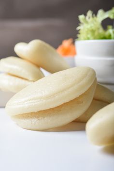 some kind of food that is on a white table with a plant in the background