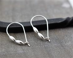 "Tiny Sterling Silver Beaded Hoop Earrings I make each pair of earrings using sterling silver wire and I solder the loop closed These have two sterling silver shiny beads. These earrings are so comfortable and stay put because of the hook closure. Earrings are: 1\" long" Everyday Silver Hoop Earrings With French Hook, Silver Dainty Earrings With French Hook, Small Silver Everyday Earrings, Small Silver Earrings For Everyday, Silver Sterling Hoop Earrings With French Hook, Everyday Silver Earrings With French Hook, Everyday Silver French Hook Earrings, Sterling Silver Drop Hoop Earrings With Lever Back, Silver French Hook Earrings For Everyday