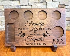 a personalized wooden cutting board with four holes for the family where life begins and the tequila never ends