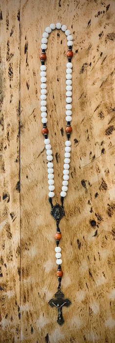 This rosary was designed by a seminarian, with the white beads representing purity and the red beads representing martyrdom. Every rosary we carry is handmade by a local priest, Father Steve Kunkel. Father Steve began making rosaries in the seminary. He started with knotted rosaries, but when he saw his deacon with a high quality wood beaded rosary it was love at first sight. He’s been making beautiful wooden beaded rosaries ever since. Each rosary is made with careful attention to detail and th Spiritual White Jewelry With Wooden Beads, White Spiritual Jewelry With Wooden Beads, White Spiritual Rosary Bracelet, White Spiritual Crucifix Necklace, White Crucifix Spiritual Necklace, White Wooden Beads Rosary As Gift, White Wooden Beads Necklace For Healing, White Rosary With Wooden Beads As Gift, White Spiritual Rosary Bracelet With 8mm Beads