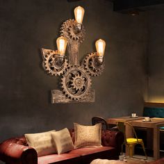 a living room filled with furniture and lamps next to a wall mounted art piece on the wall