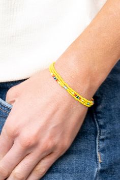 Two strands of dainty Illuminating seed beads, highlighted with a strand of brightly colored beads, form a simple accent around the wrist. Features an adjustable sliding knot closure.

 Sold as one individual bracelet. Adjustable Sliding Knot, Sell Jewelry, Sliding Knot Closure, Bracelets For Boyfriend, Happy Jewelry, Yellow Bracelet, Yellow Jewelry, Dainty Bracelet, Beads Earrings