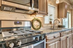 a kitchen with an oven, stove and sink in it's center island area