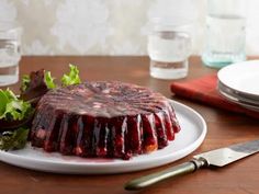 a plate with a cake covered in jelly and garnished with lettuce