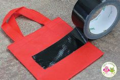 a red bag with a black tape on it and an owl sticker next to it