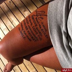 a person with a tattoo on their arm that has words written on the back of it