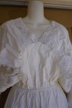 "Vintage batwing white lace dress. No tags -estimated size large. Good vintage condition - no flaws to note! Measurements taken across front lying flat open\" across front armpit to armpit 11\" across front of waist -m stretches to 18\" 52\" length shoulder to bottom" Daywear Long Sleeve Lace Dress With Lace Trim, Long Sleeve Lace Dress For Daywear, White V-neck Lace Top With Lace Sleeves, White Lace Collar V-neck Top, White Lace Dress With Lace Cuffs For Summer, White Lace Dress With Lace Cuffs, White Lace With Long Sleeve Patchwork, White Lace With Long Sleeves And Patchwork, White Lace Collar Top For Daywear