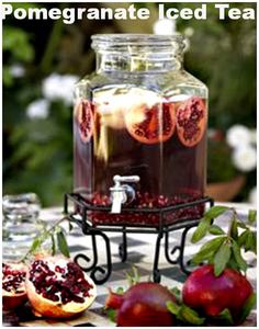 a glass jar filled with liquid sitting on top of a table next to sliced fruit