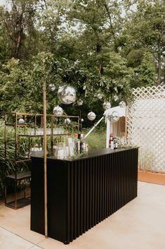 an outdoor bar is set up in front of some trees