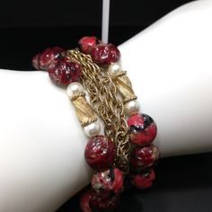 *Description: This is a beautiful Kramer red bracelet and clip earrings from the late 1940s to early 1950s. I tested the gold on the bracelet and it tested at 22K gold surface metal. The red beads are molded so they would be made of thermoset and they have gold glitter inside in places. There are two twisted gold beads with faux pearls on each side, three rows of gold chain on the bracelet with two rows of red art beads. The earrings have matching red solid beads with the same tones and are sign Vintage Gold Beads Jewelry Gift, Vintage Gold Beaded Bracelets, Vintage Beaded Bangle Bracelets For Party, Vintage Red Bracelets For Party, Vintage Yellow Gold Jewelry For Festive Occasions, Elegant Red Bracelets With Gold Beads, Red Vintage Party Bracelets, Vintage Bangle Jewelry For Festive Occasions, Vintage Bangle For Festive Occasions