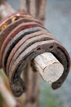 an old rusty pipe with some rust on it's end and one piece of wood sticking out of it