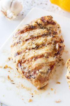 a piece of meat sitting on top of a white cutting board