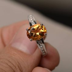 This is a gorgeous handmade creation. Its beauty is its simplicity & Elegance. The 7*9 mm oval shape faceted natural citrine is crafted in solid sterling silver and with rhodium plated. All item is sent in a beautiful gift box If you have any idea of design your ring,pls contact me directly. You can realize more lovely stuff clicking the link https://www.etsy.com/shop/knightjewelry?refshopsection_shophome_leftnav Please leave the correct address and you phone number for delivering successful Yellow Gemstone Ring, Cushion Cut Wedding Rings, November Birthstone Ring, Brown Gemstone, Smoky Quartz Ring, Yellow Gemstones, London Blue Topaz Ring, Citrine Stone, Citrine Ring